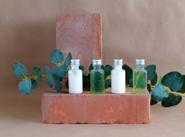 Body care product in shower and shampoo on stone, on brown background. The concept of daily skin care. Plastic bottle of shampoo with floral fragrance. Simple example of shampoo.