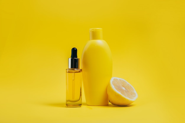 Body care products and  lemon on yellow