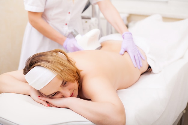 Photo body care. woman is in the process at the clinic lipomassage