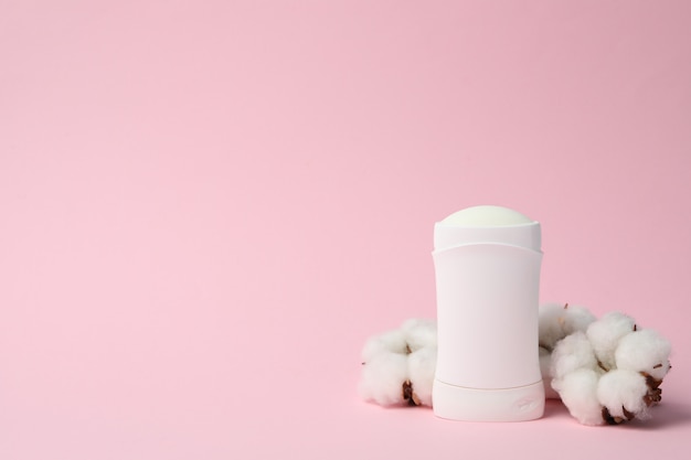 Body deodorant and cotton on pink