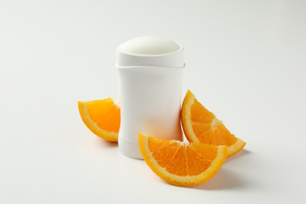 Body deodorant and orange on white