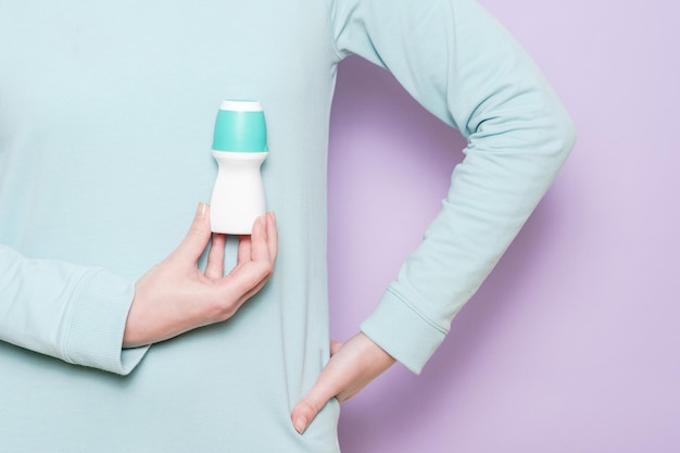 A body deodorant rollon in woman's hand