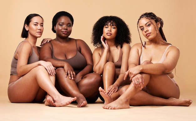 Body diversity and portrait of natural women group together for inclusion beauty and power Aesthetic model people or friends on beige background with skin glow pride and motivation for self love