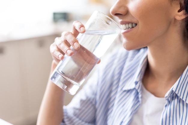 Body hydration concept young lady enjoying mineral water thirsty woman drinking refreshing liquid