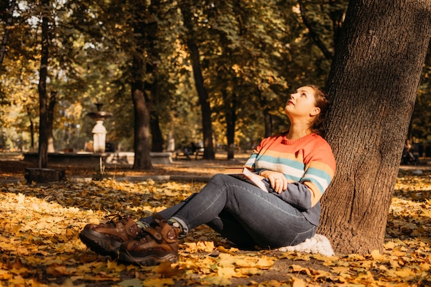 Body shaming low selfworth concept sad plus size woman walking in autumn park