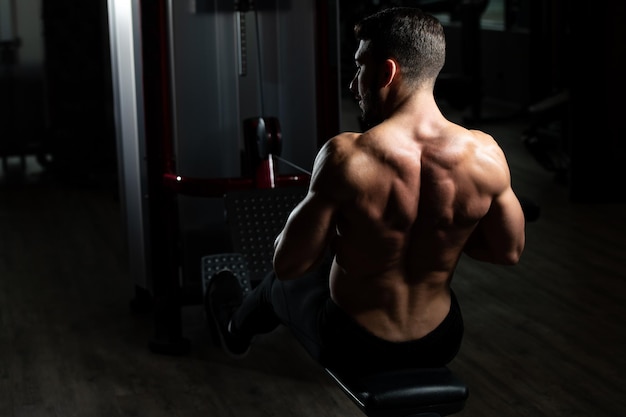 Bodybuilder Exercising Back In Gym