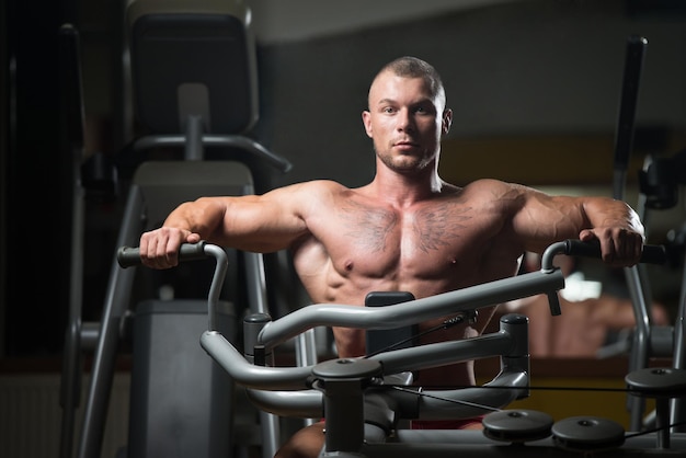 Bodybuilder Exercising Back In Gym