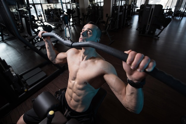 Bodybuilder Exercising Back In Gym