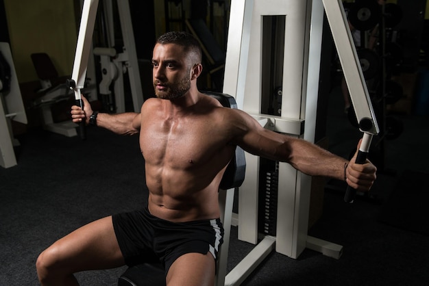 Bodybuilder Exercising Chest On Machine