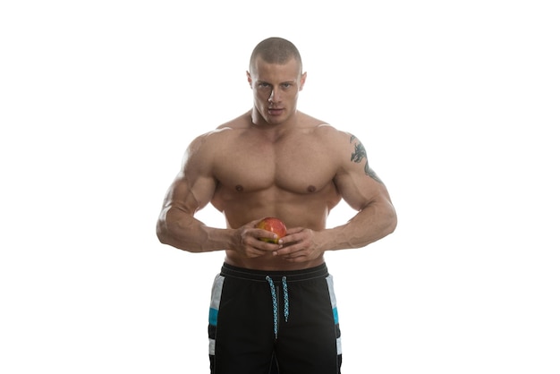 Bodybuilder Holding Apple Isolated On White Background