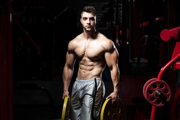 Bodybuilder Holding Weights In Hand