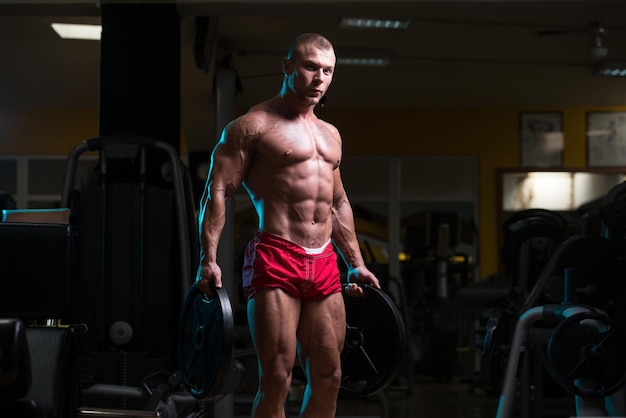 Bodybuilder Holding Weights In Hand