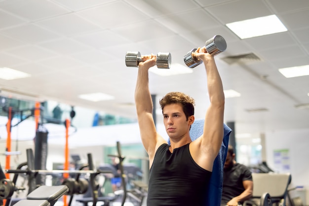 Bodybuilder lifting dumbbells