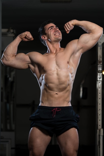 Bodybuilder Posing In Different Poses Demonstrating Their Muscles  Male Showing Muscles Straining  Beautiful Muscular Body Athlete