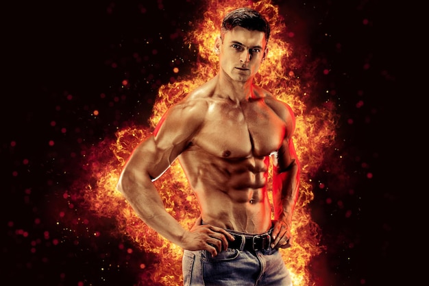 Bodybuilder posing on the fire flames background