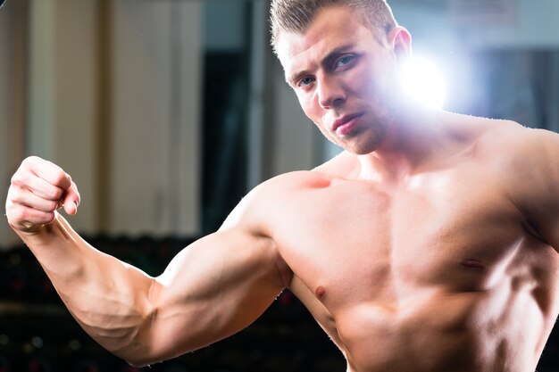 Bodybuilder posing in Gym