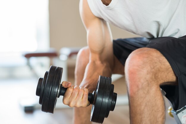 Bodybuilder using a dumbbell to work out