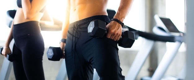 Bodybuilder working out with dumbbell weights. Close up hand of Bodybuilder with dumbbell in hand