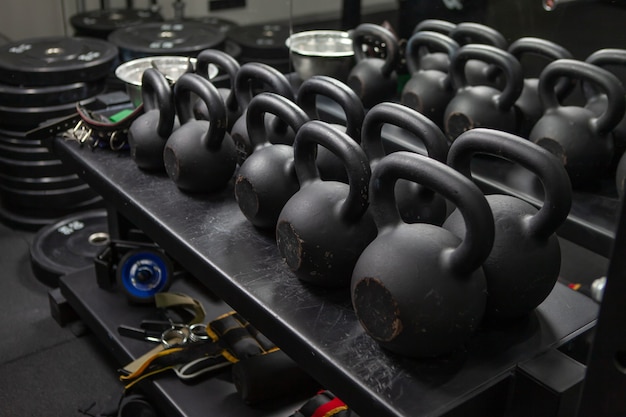 Bodybuilding, free weight equipment. A rack with kettlebells and fitness accessories in a modern gym. Functional training