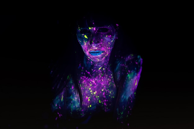 Photo bodypainting on nude girl painted with uv colors