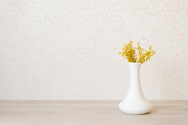 Boeket gele mimosa bloemen in een vaas Concept van vrouwen- of moederdag