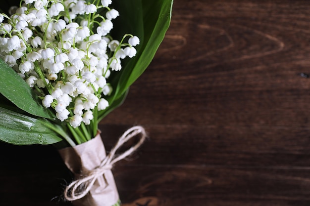 Boeket van jonge lelietje-van-dalen op een houten tafel