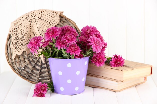 Boeket van roze chrysant in emmer op witte houten achtergrond