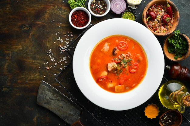 Bograch soup Hungarian cuisine Soup with meat vegetables and chili peppers In a white plate Top view