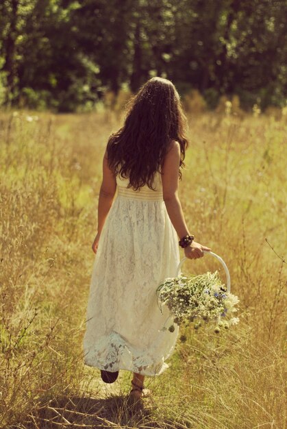 Boho bride walking in golden field