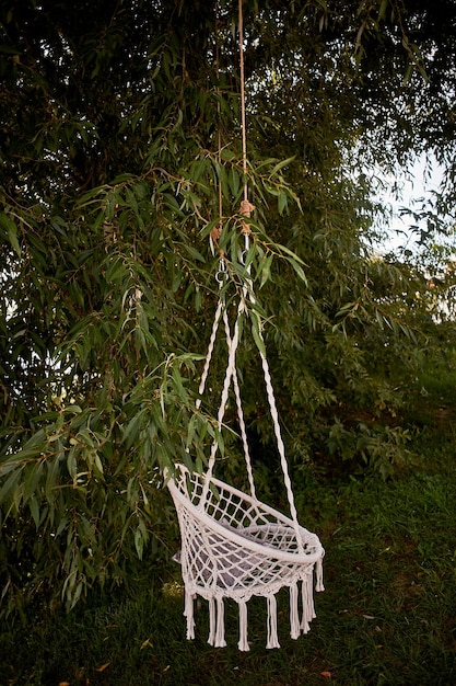 Boho style wedding decorationease and simplicity swing knitted\
macrame hanging out in nature hammock for relaxation boho\
style