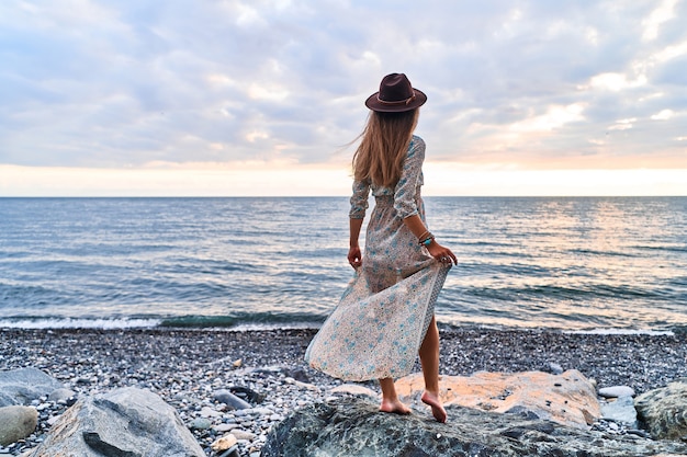 Boho woman in long dress and felt hat