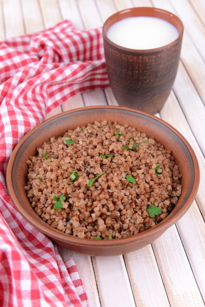 Boiled buckwheat in bowl on table