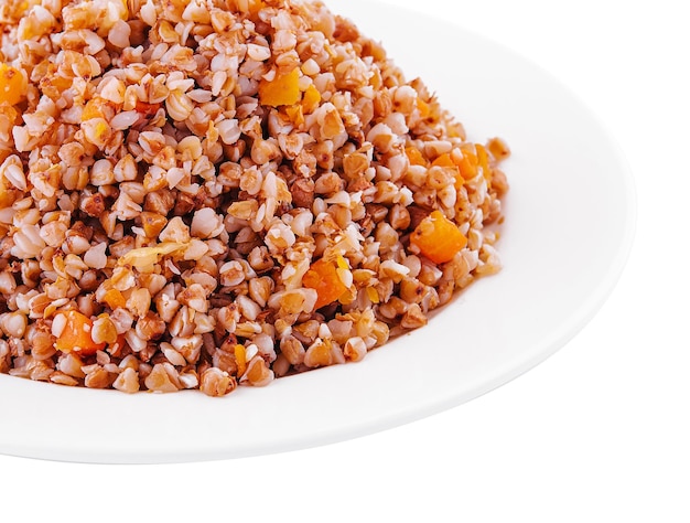 Boiled buckwheat on plate isolated on white