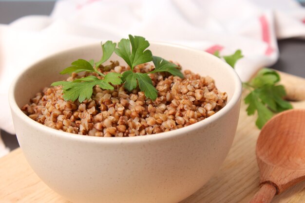 Boiled buckwheat in a plate on the table