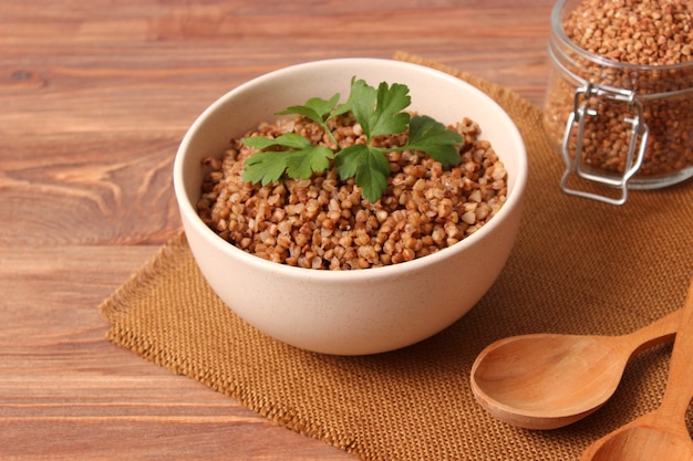 Boiled buckwheat in a plate on the table