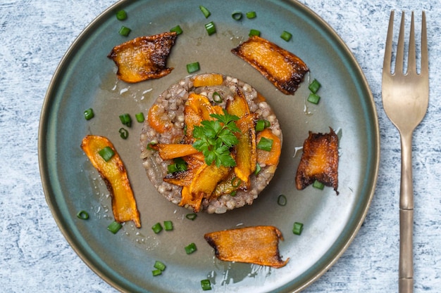 Boiled buckwheat with fried carrots and onions close up