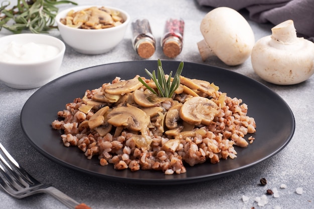 Boiled buckwheat with stewed mushrooms. Russian traditional food. Healthy diet food.