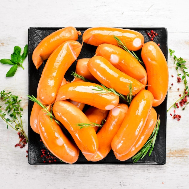 Boiled chicken sausages with spices and rosemary Barbecue Top view Rustic style