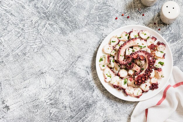 Boiled chopped octopus on a concrete table