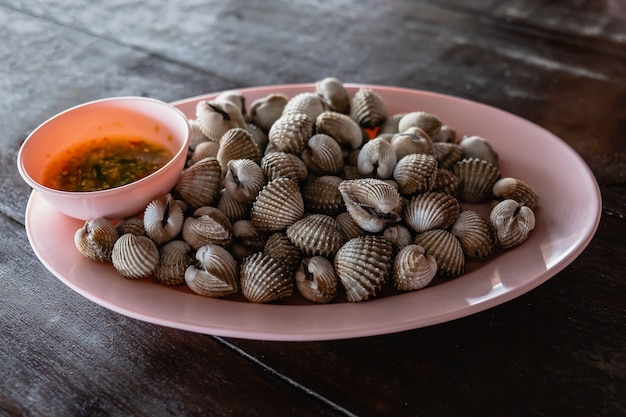 Boiled cockles with tasty sauce in the dish