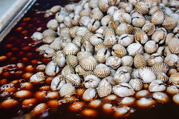 Boiled cockles with tasty sauce.