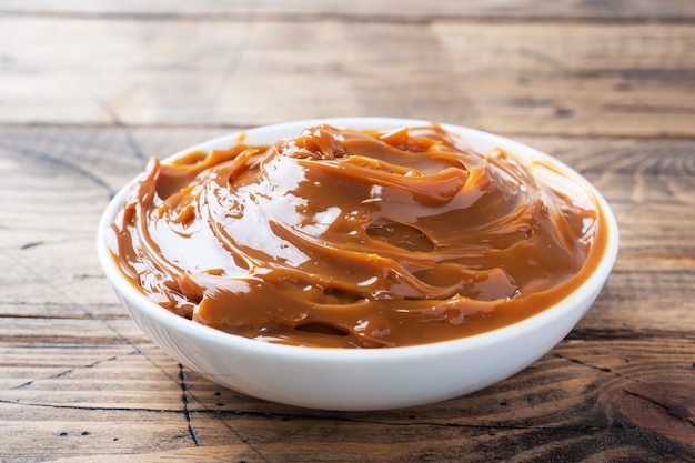 Boiled condensed milk in a plate. Sweet pasta spread for Breakfast and dessert. Copy space.