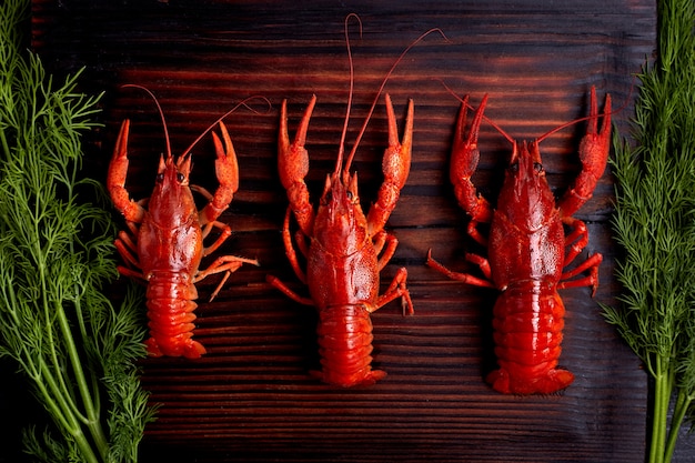 Boiled cooked crayfish crawfish ready to eat on dark wooden background