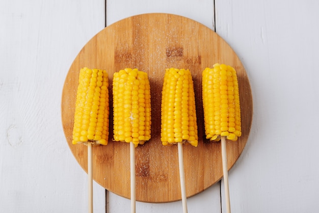 Boiled corn on a white wooden natural background 1