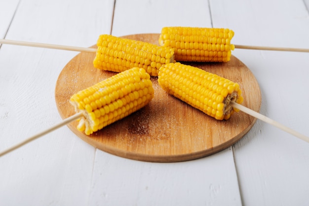 Boiled corn on a white wooden natural background 1
