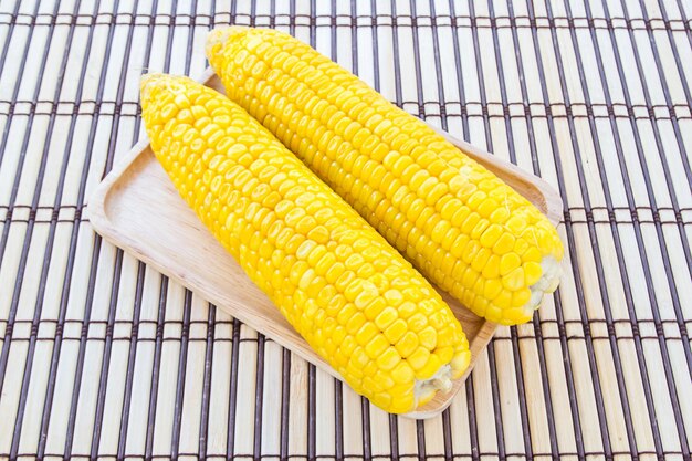 Boiled corn in wooden plate