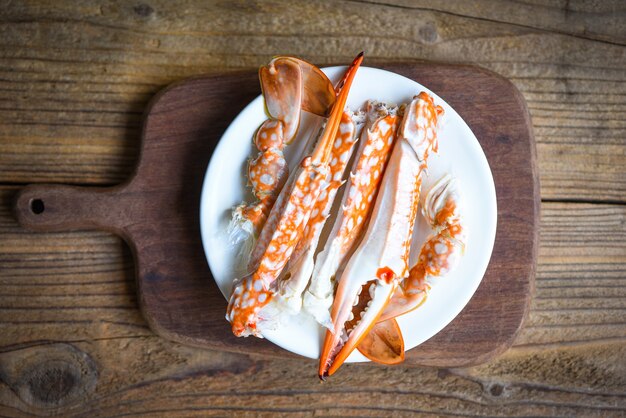 Boiled crab food on wooden board on the table, crab claws shellfish