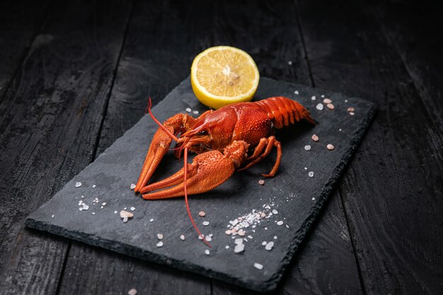 Boiled crab with lemon and salt on a slate plate