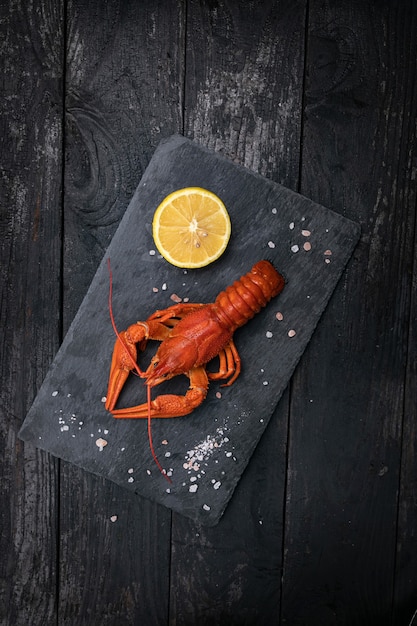 Boiled crab with lemon and salt on a slate plate