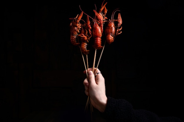 Boiled crayfish on a black background in the air